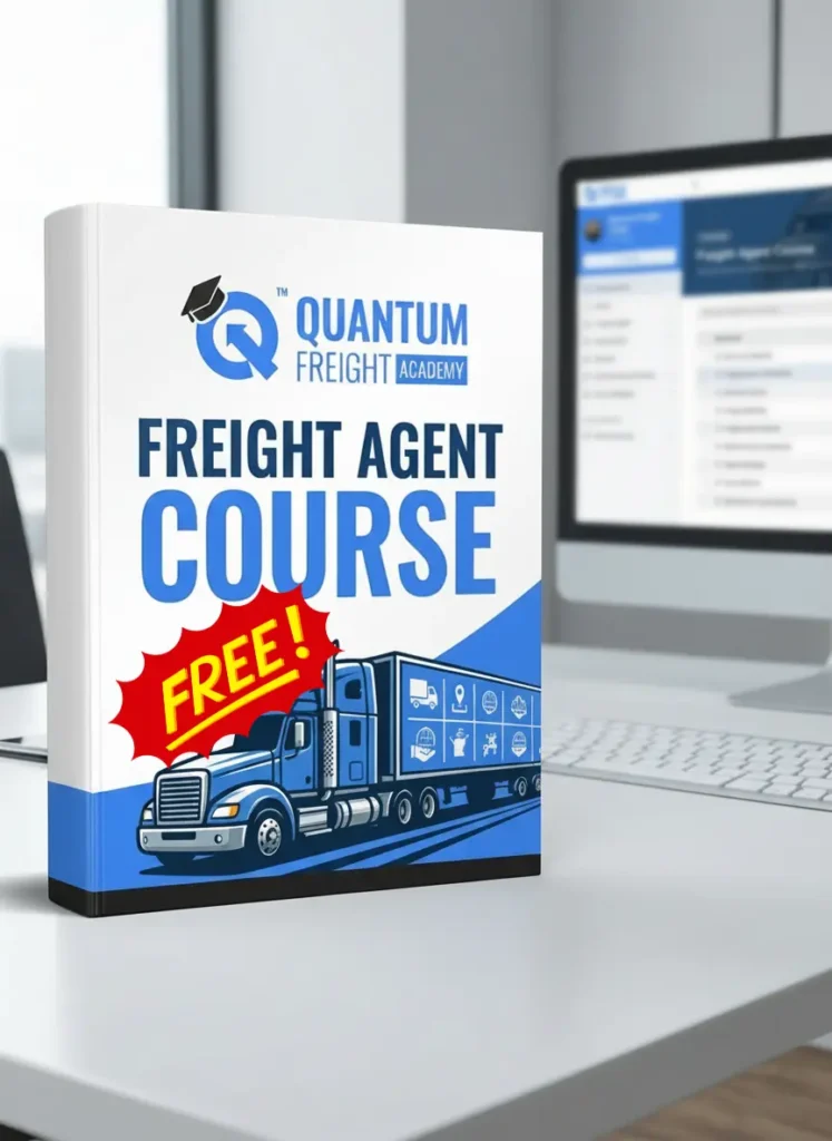A 3D mockup of a white and blue textbook titled "FREIGHT AGENT COURSE" stands prominently on a white desk in a modern office setting. The book features the Quantum Freight Academy logo at the top, a large red starburst sticker that screams "FREE!", and a detailed illustration of a blue semi-truck on the bottom half. In the blurred background, a computer monitor displays a course interface, a keyboard, and a white mouse, all suggesting a professional remote learning environment.